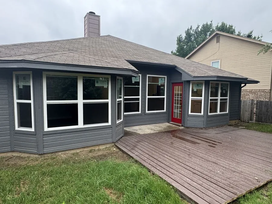 Home exterior with newly installed windows and red front door