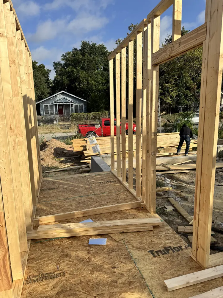Wall framing crew at work on new construction, Dallas TX