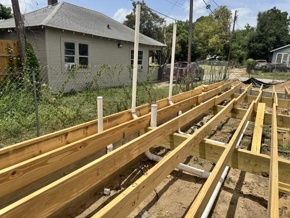 Plumbing rough-in across floor framing